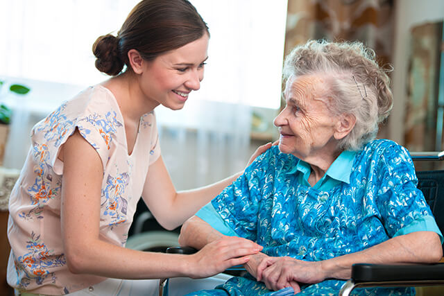 An elderly person and caregiver sharing a moment of companionship