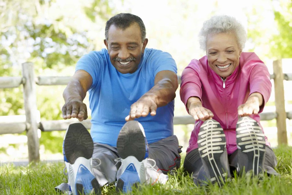 elderly couple participating in a gentle exercise