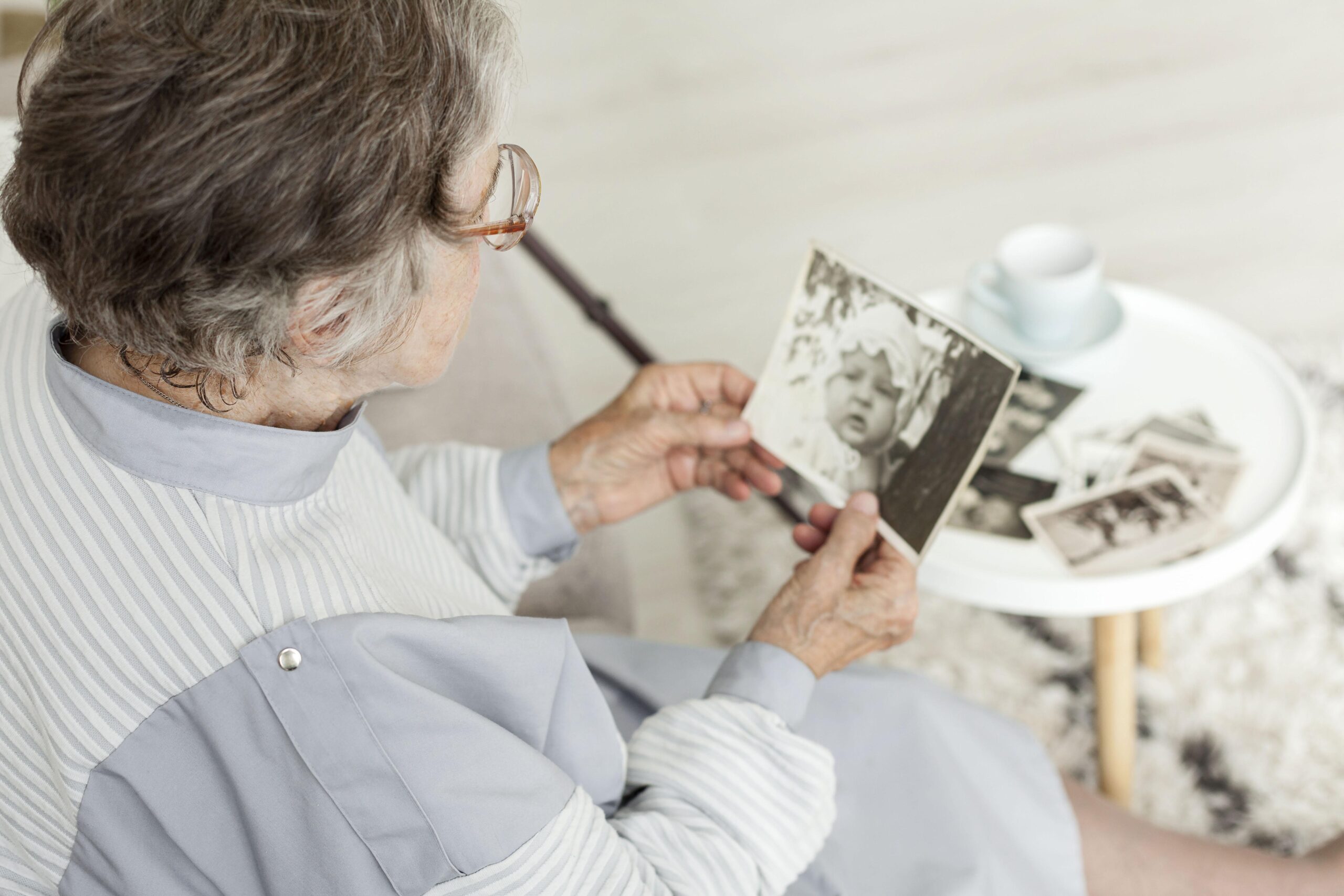 Grandmother looking at old family pictures.